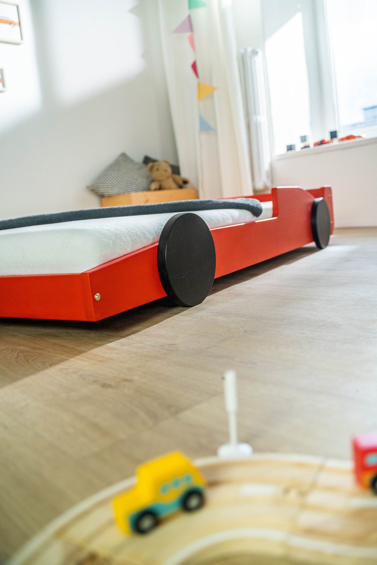 Racer autobed 80×160 in rood, zijaanzicht van dichtbij met beddengoed
