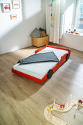 Racer autobed 80×160 in rood, schuin vooraanzicht met opgemaakt bed