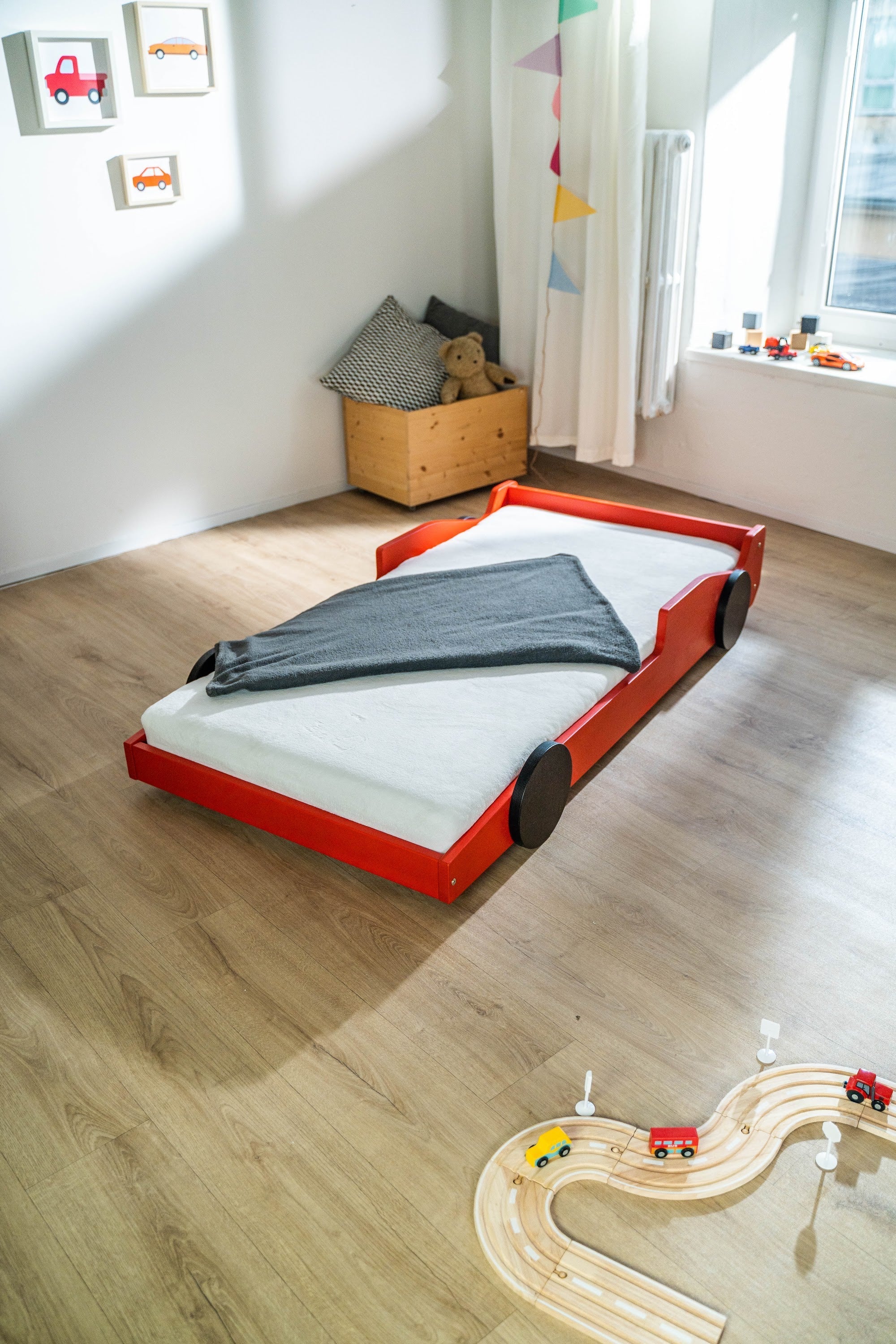 Racer autobed 80×160 in rood, schuin vooraanzicht met opgemaakt bed